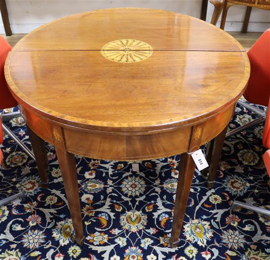 A pair of George III mahogany D shaped folding tea tables W.90cm